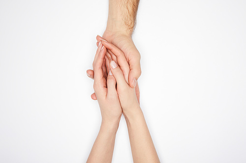 top view of couple holding hands isolated on white