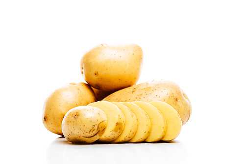 raw whole and sliced fresh potatoes isolated on white