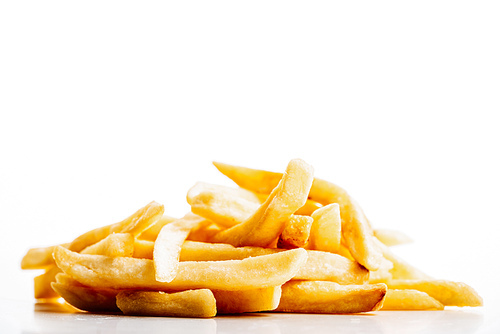 heap of fresh golden french fries isolated on white