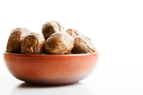 delicious jacket potato in clay bowl on white background