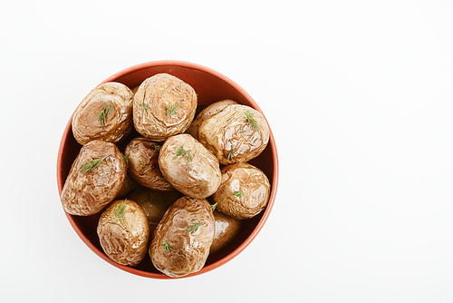 top view of delicious jacket potato with dill in clay bowl isolated on white