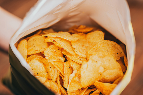 close up view of delicious crispy potato chips in package