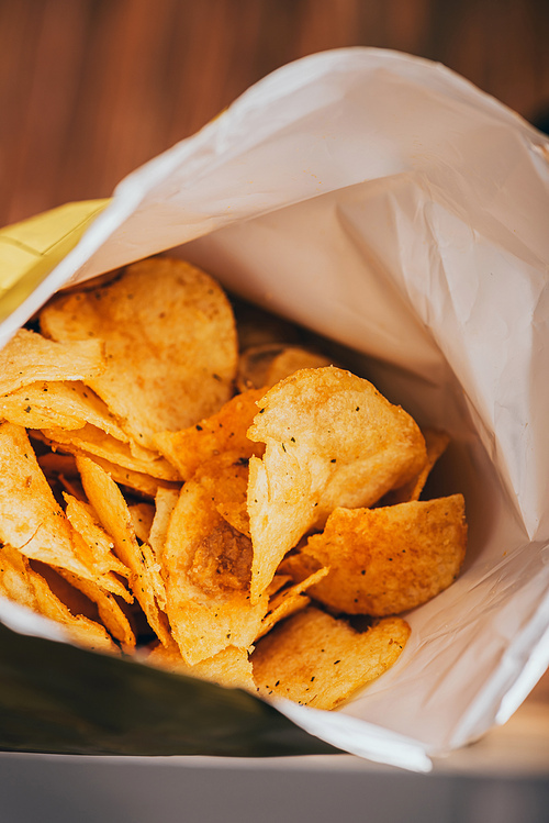 close up view of delicious crispy potato chips in package