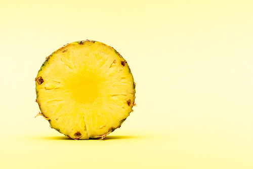 delicious sweet cut pineapple on yellow background