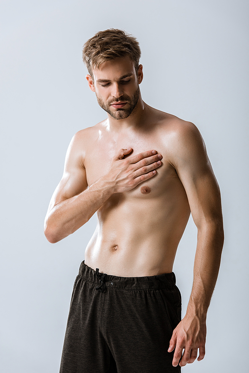 shirtless bearded man with chest pain isolated on grey