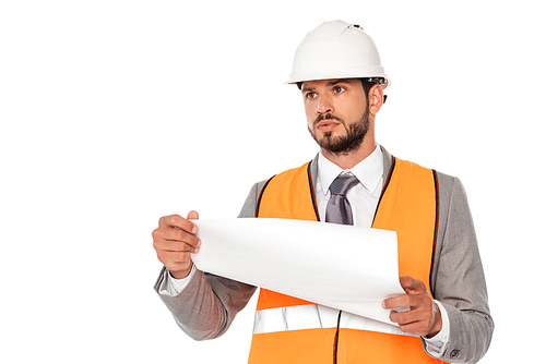 Handsome engineer in suit and hardhat holding blueprint and looking away isolated on white