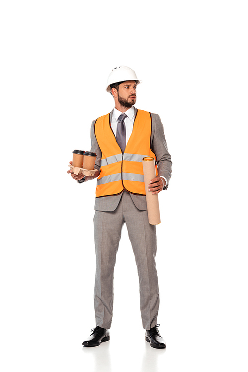 Engineer in suit and hardhat holding paper cups and blueprint tube on white background