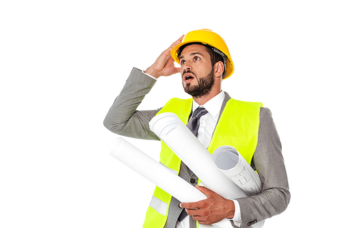 Shocked engineer in suit holding blueprints and looking away isolated on white