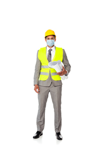 Engineer in suit, safety helmet and medical mask holding blueprints on white background