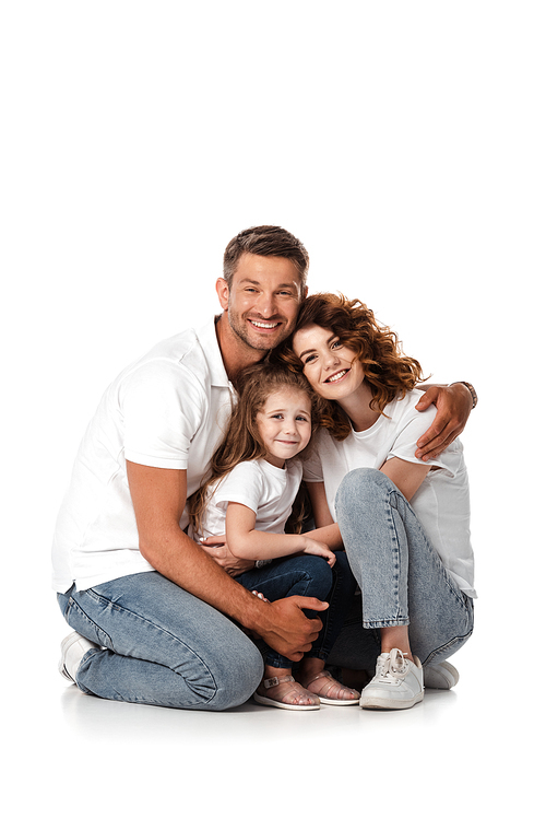 happy man hugging wife and daughter on white
