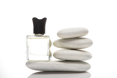 home perfume in bottle near spa stones on white background