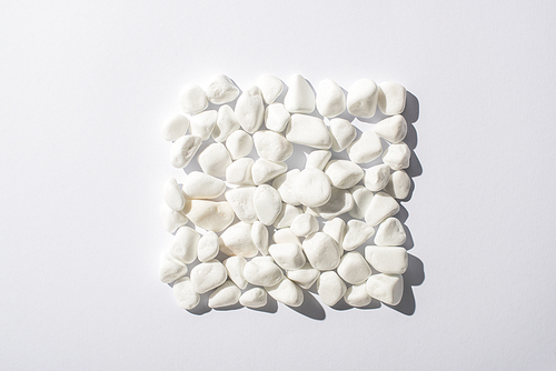 top view of stones arranged in square on white background