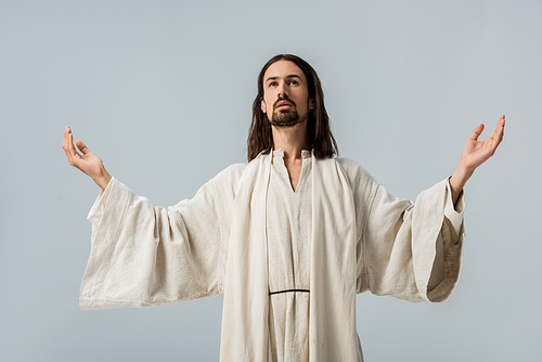 handsome man in jesus robe with outstretched hands isolated on grey