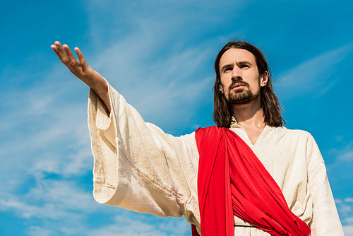 low angle view of jesus with outstretched hand