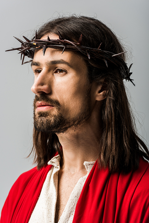 handsome bearded man in wreath with spikes isolated on grey