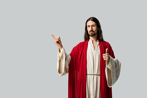 man in jesus robe showing thumb up and gesturing isolated on grey