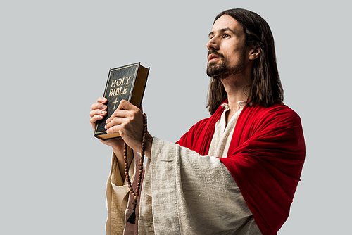 handsome jesus holding holy bible isolated on grey