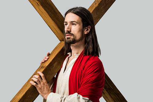 jesus holding wooden cross isolated on grey