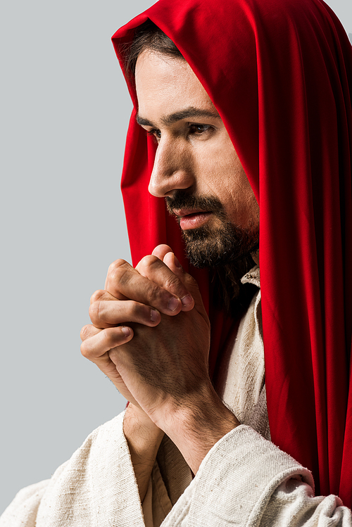 handsome bearded man praying isolated on grey