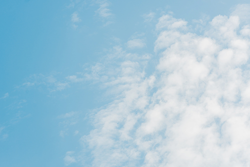 blue sky with white fluffy clouds and copy space