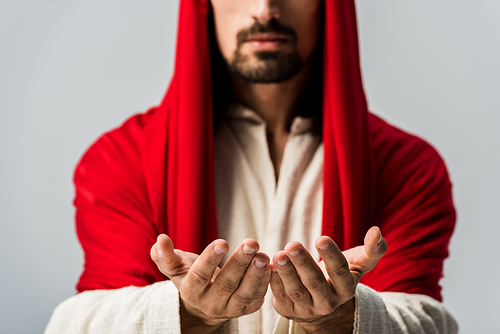 selective focus of bearded man with cupped hands isolated on grey