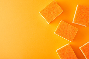 top view of orange sponges for dish washing on orange