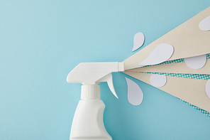 composition with spray bottle and white water drops made of paper, on blue