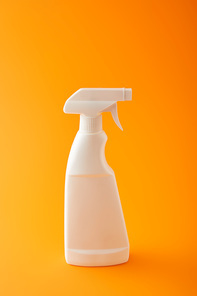 one white spray bottle on orange, cleaning home product