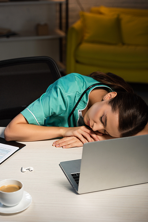 attractive nurse in uniform sleeping on table during night shift