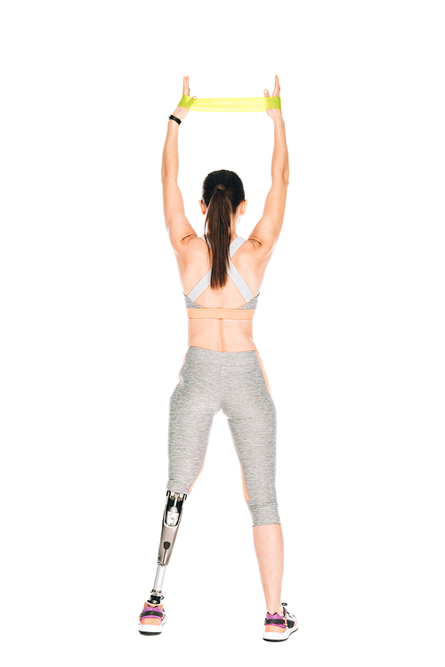back view of disabled sportswoman with prosthesis training with resistance band isolated on white