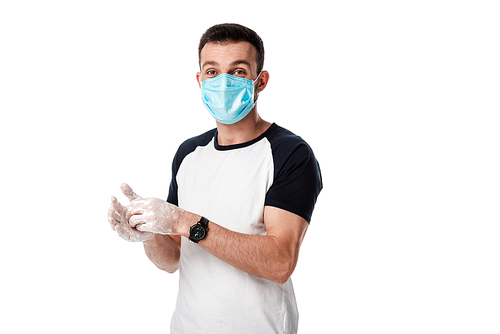 man in medical mask washing hands while standing isolated on white