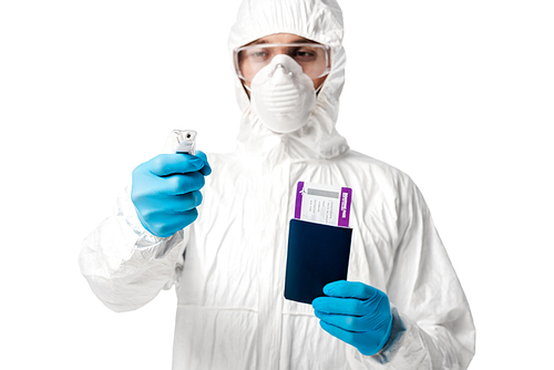 selective focus of man in hazmat suit holding pyrometer and passport with boarding pass isolated on white