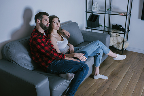 pretty girl  while watching tv with boyfriend at home