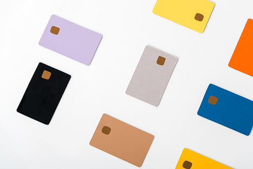 top view of multicolored credit card templates isolated on white