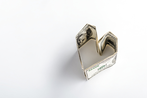 heart-shaped dollar banknotes on white with copy space