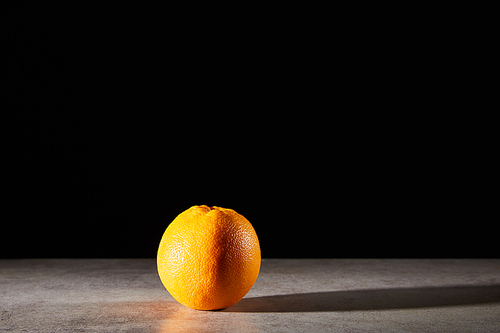 whole and ripe orange isolated on black with copy space