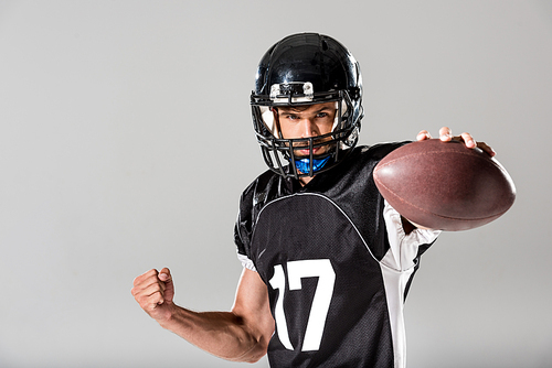 American Football player in helmet with ball Isolated On grey