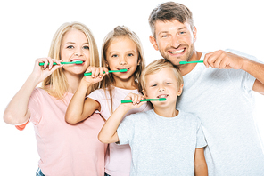 happy parents and children holding toothbrushes while brushing teeth isolated on white