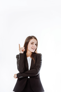 smiling confident businesswoman in suit pointing with finger up isolated on white