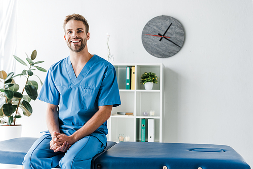 cheerful doctor  while sitting in clinic