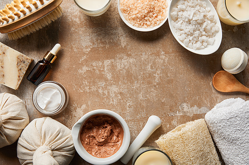 top view of natural cosmetic ingredients on textured weathered beige surface