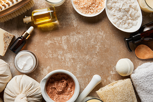 top view of natural cosmetics on textured weathered beige surface