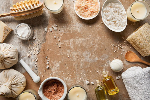 top view of natural cosmetic ingredients and beauty supplies on textured weathered brown surface