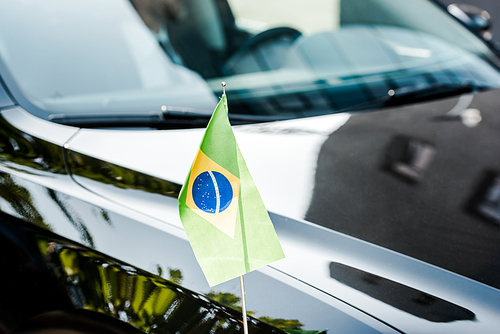 selective focus of brazilian flag on modern car