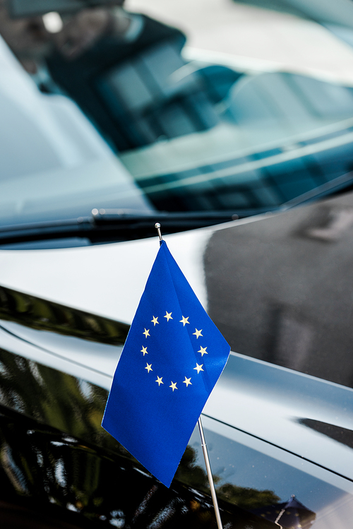 selective focus of european union flag near black car