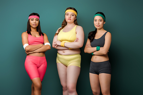 Sportswomen with crossed arms  on green background