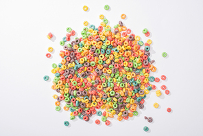 top view of bright multicolored breakfast cereal on white background