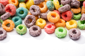 close up view of bright multicolored breakfast cereal on white background