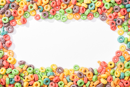 top view of bright multicolored breakfast cereal arranged in frame on white background