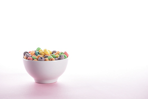 bright multicolored breakfast cereal in bowl on white background